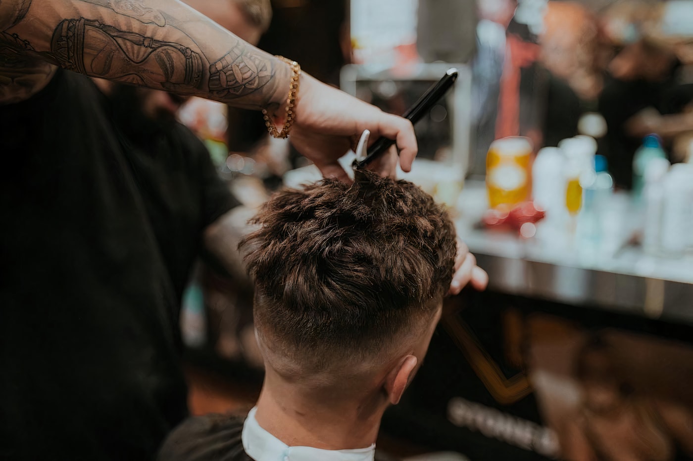 Textured crop with a tapered fade being combed through