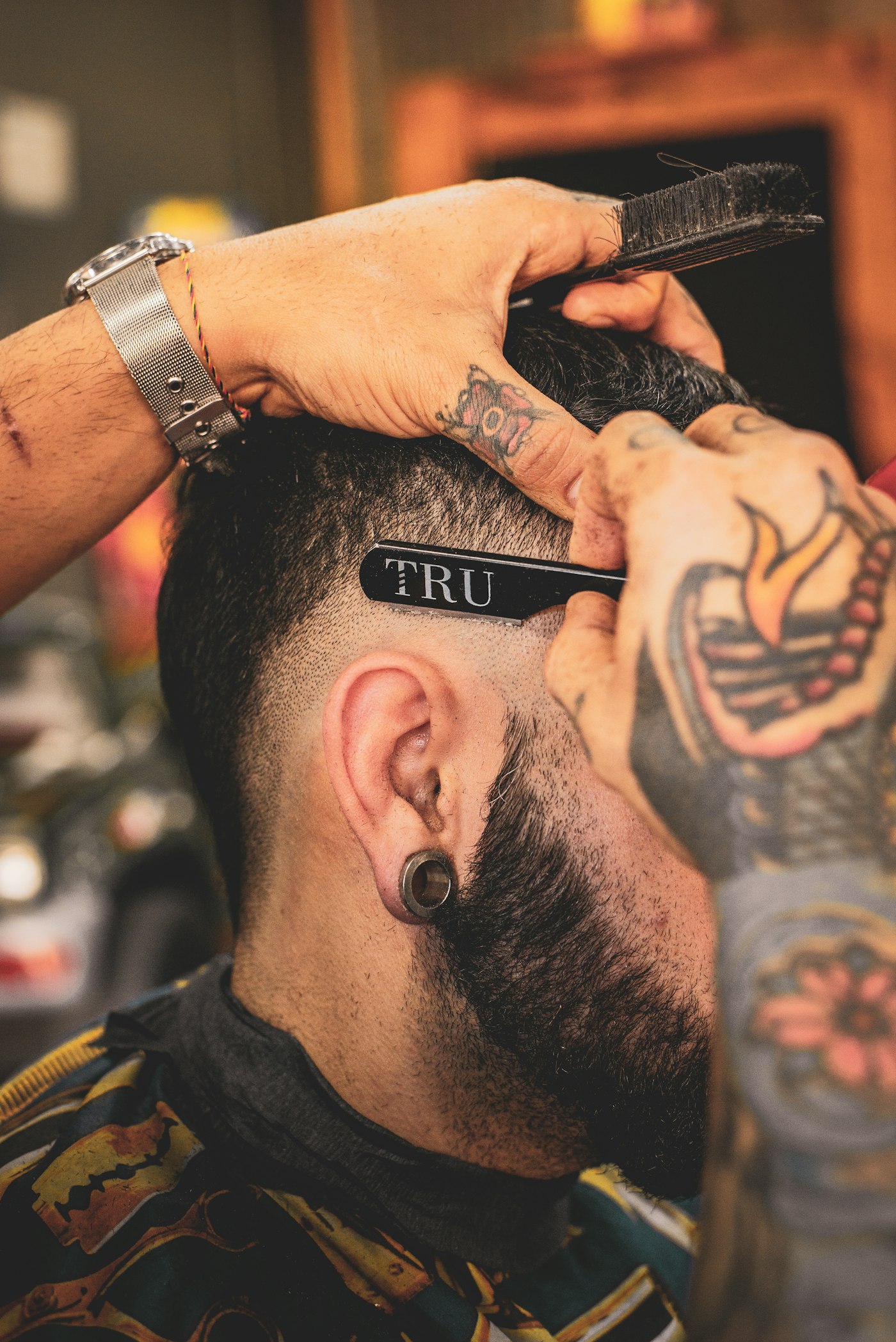 A precise straight-razor neckline on a skin fade