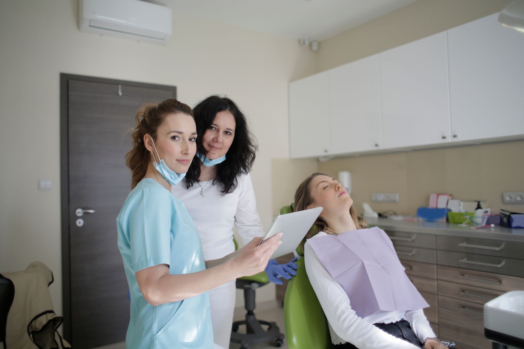 Dental team reviewing a scan with a relaxed patient in the chair