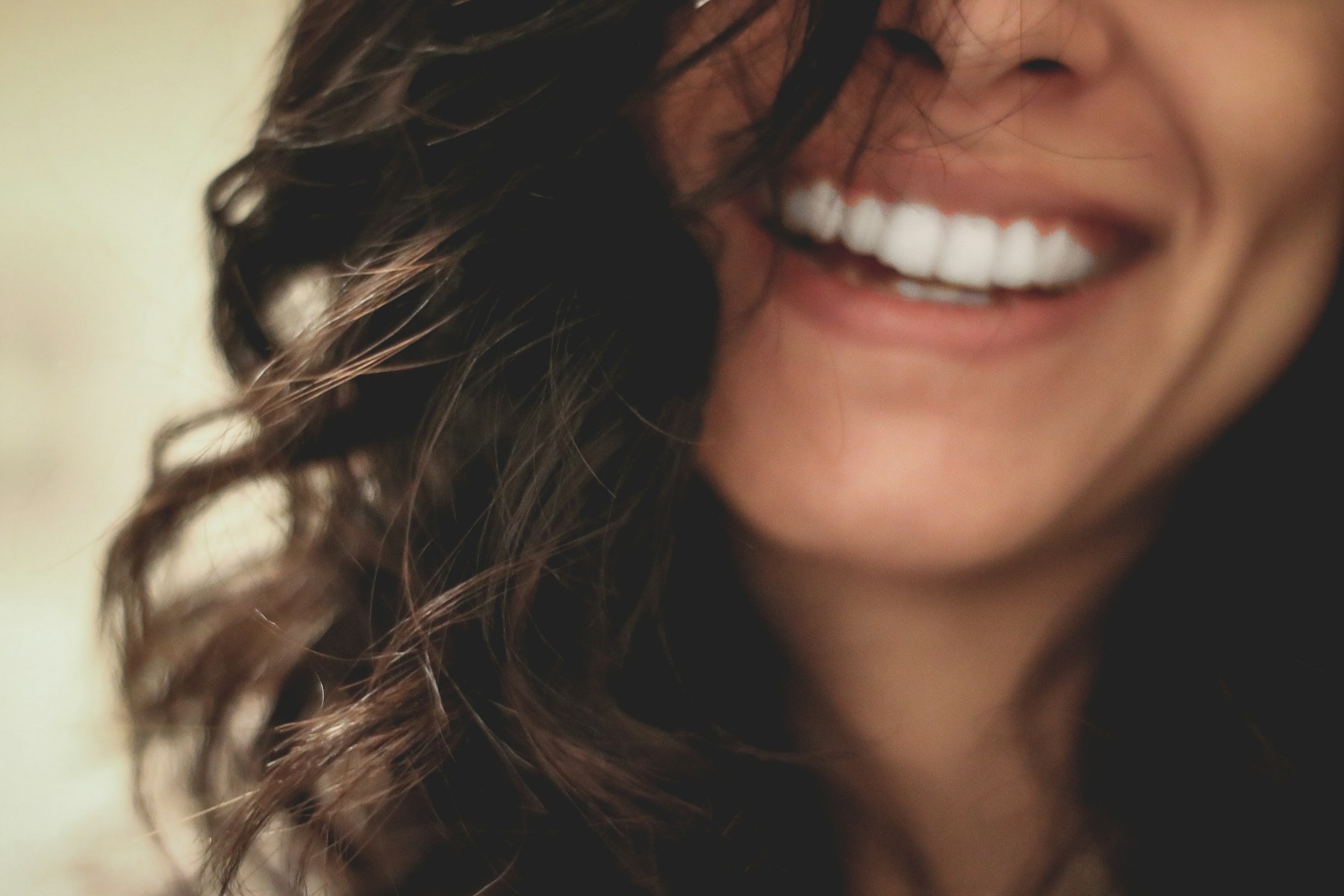 A patient laughing, mid-smile