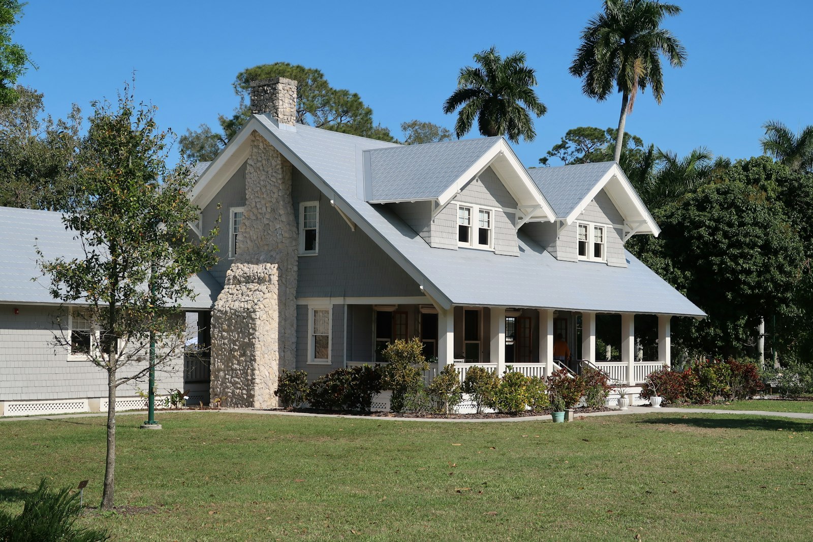 Completed steel-roofed home with clean ridgelines and gutters
