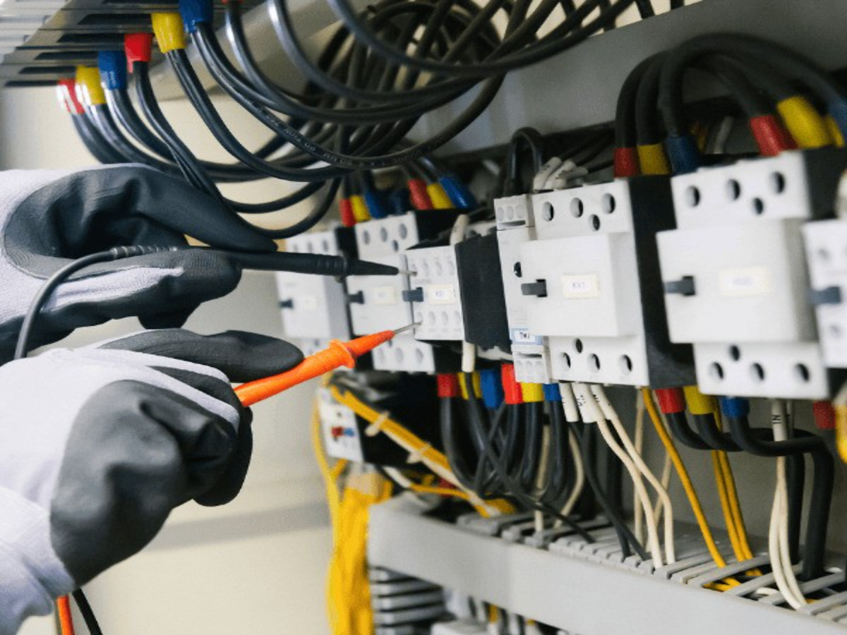 Electrician testing a switchboard with a multimeter