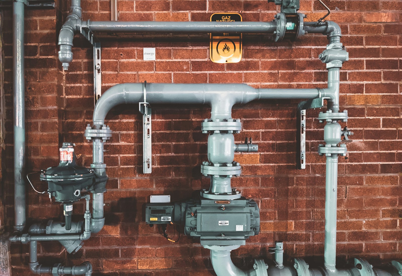 Grey drainage pipework routed across a wall