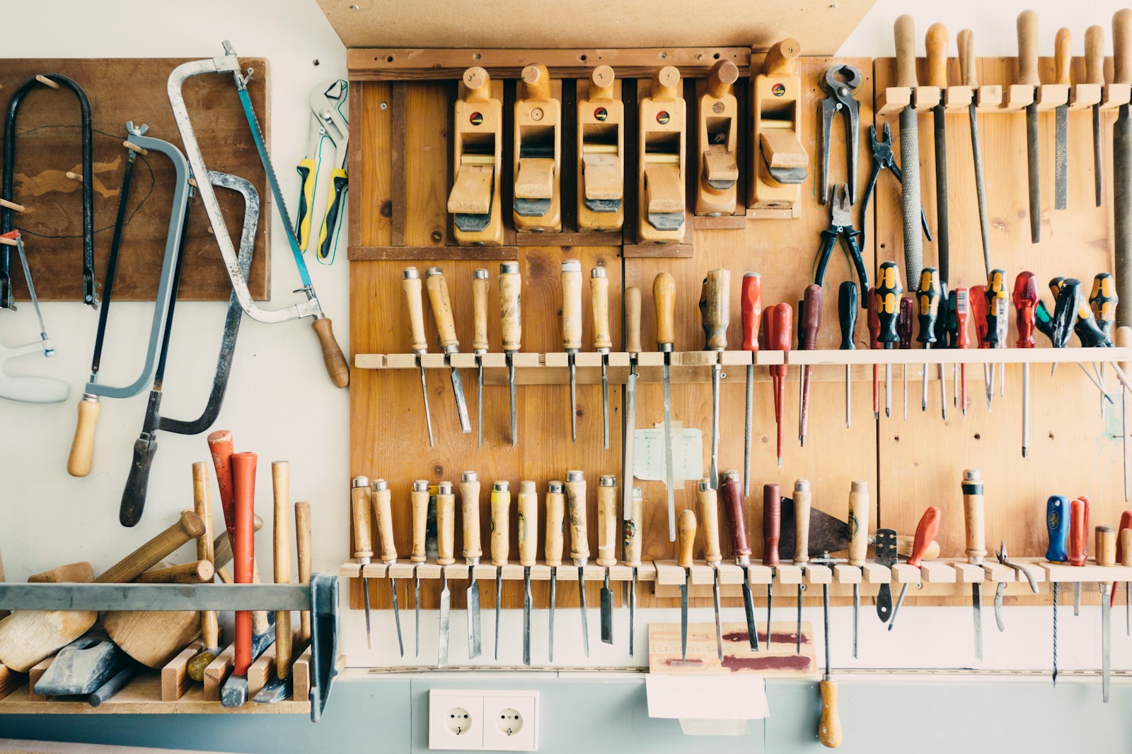 A working tool wall — saws, planes, chisels and screwdrivers, each in its place